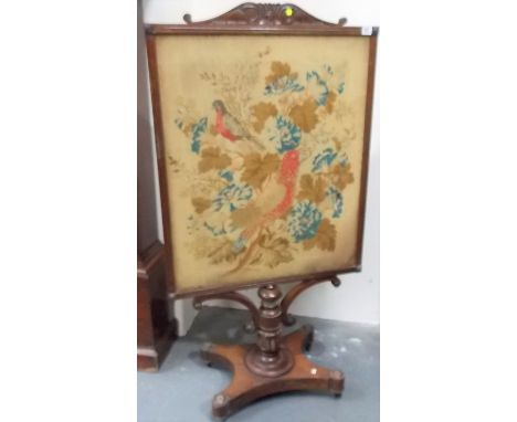 19th Century rosewood pedestal fire screen, the rectangular frame with scroll carved top, with a tapestry woolwork inset depi