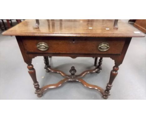 Late 17th Century oak side table, the rectangular moulded top over a frieze drawer upon turned supports united by a crossed s