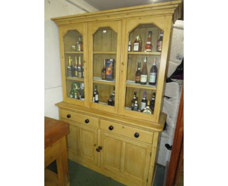 Glazed pine dresser, the upper section with a middle glazed panel and glazed door to each side, brass handles, two plate rack