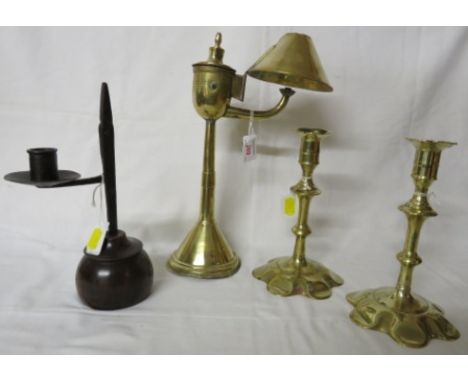 An iron rush light on a turned fruitwood base (height 24.5cm), a brass oil lamp with reservoir at the top, arm and conical sh