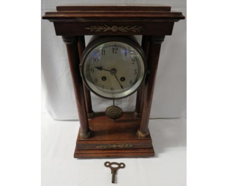 Oak chiming mantel clock, barrel case raised between the top of four Doric columns, gilt brass foliate mounts to pediment and