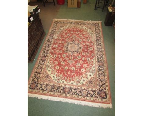 A pale red ground carpet with five margins and scrolled foliate patterning (200cm x 300cm)