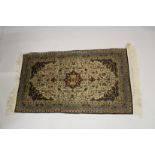 A GOOD SMALL PERSIAN SILK RUG beige ground with all over stylised decoration. 5ft x 3ft.