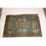 A FINE PERSIAN SILK RUG turquoise ground with stylised motifs and medallions. Signed. 6ft 6ins x 4ft
