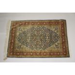 A GOOD SMALL PERSIAN BLUE RUG blue and beige ground with stylised floral decoration. 5ft ins x 3ft