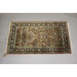 A PERSIAN PART SILK RUG salmon ground decorated with a vase of flowers and birds. 5ft 5ins x 3ft
