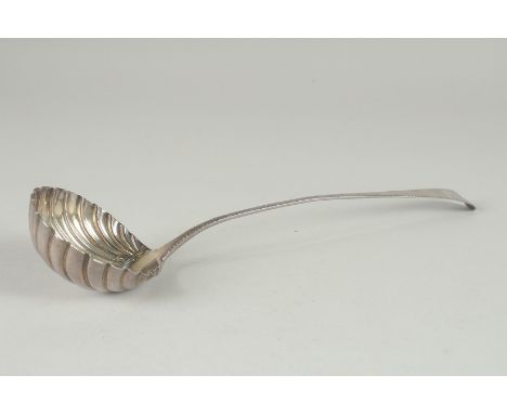 A GEORGE III SILVER LADLE with shell shaped bowl, marks indistinct. 13ins long.