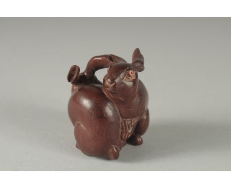 A  CARVED WOOD TWO RABBIT NETSUKE, Signed, 2ins high.
