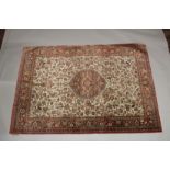 A GOOD PERSIAN SILK CARPET cream ground with floral decoration with a red ground border. Signed. 6ft
