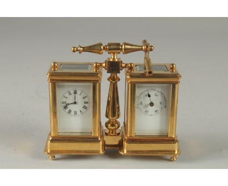 A GILT DOUBLE MINI CARRIAGE CLOCK with carrying handle.  4ins high.