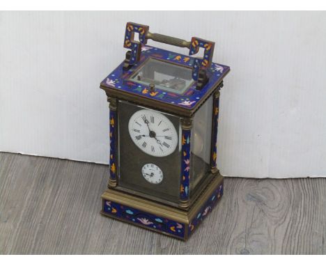 An early 20th Century Oriental carriage clock in a brass case with cloisonné enamel pillars and faces, the Roman enamelled di