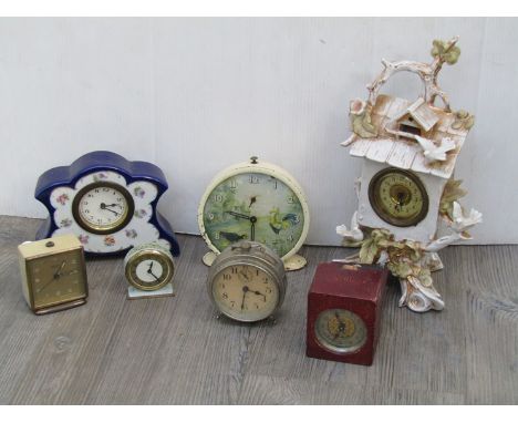 Two early 20th Century ceramic cased timepieces and five others in metal cases (7)