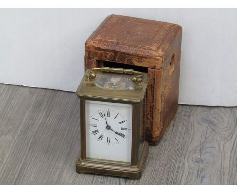 An early 20th Century French brass cased carriage clock, striking a coiled gong, Roman enamelled dial, with key, case and spa
