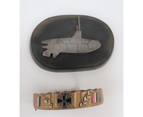 Two WW1 Trench Art Souvenirs consisting gilt brass shell driving band bracket with central enamel Iron Cross and enamel flags