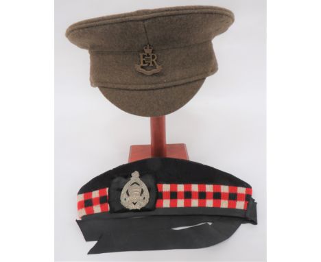 Scottish Glengarry dark blue body with lower red, white and black checkered band. Black silk tails and badge backing. White m