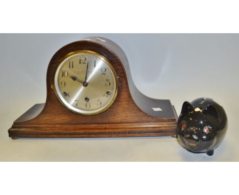 A 1930s oak Napoleon hat mantel clock; a black ceramic piggy bank (2)