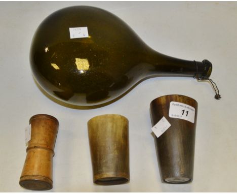 A pair of horn beakers; a dark green flask bottle; a treen dice shaker