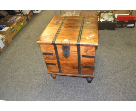A Sheesham trunk on turned feet