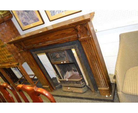 A Victorian / early 20th century cast iron fire surround, tiled hearth, Art Nouveau style tiles