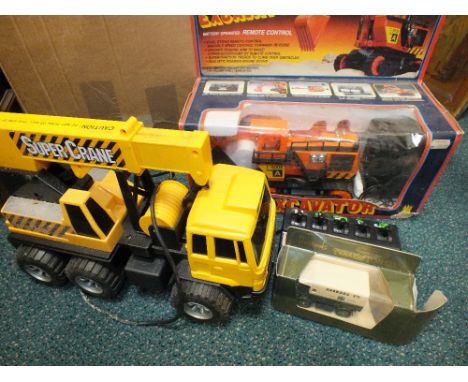 Four battery operated large scale toy vehicles, a Cat Power Dumper (boxed), an Excavator (boxed), a lorry mounted crane and t