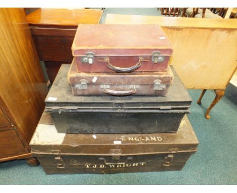 A brown  painted tin trunk marked T. J. B Wright, a black painted tin trunk and two leather suitcases