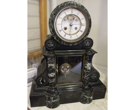 A late 19th century black slate &amp; marble mantle clock, the white enamel dial with Roman numerals, having outside brocot m