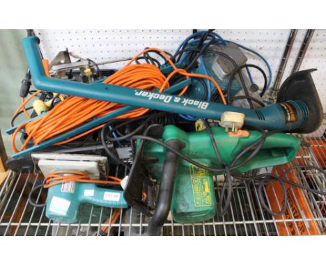 A collection of six power tools, strimmer, drills, etc