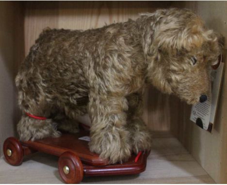 A Merrythought Roller Bear, limited edition 283 0f 500, mohair raised on a wooden trolley base