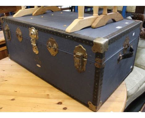 A large blue vintage travel trunk