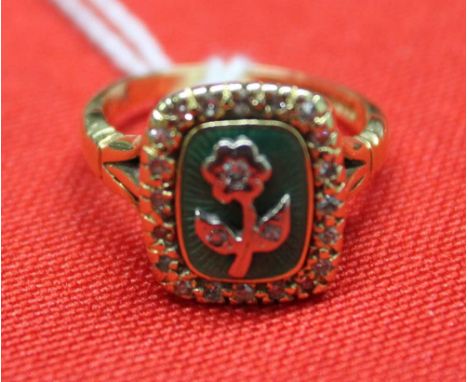 An 18ct gold ring, inset enamel panel with flower inset &amp; old cut diamonds 6.9g