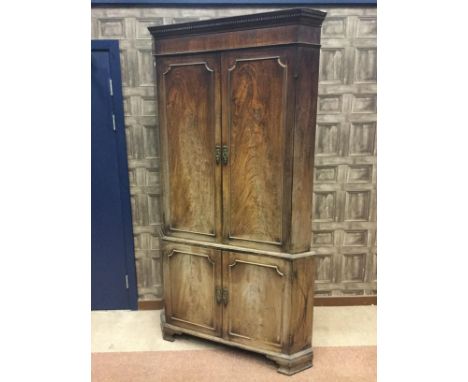 REGENCY MAHOGANY TWO STAGE CORNER CUPBOARD, of large proportions, the moulded dentil cornice the shaped shelving below enclos