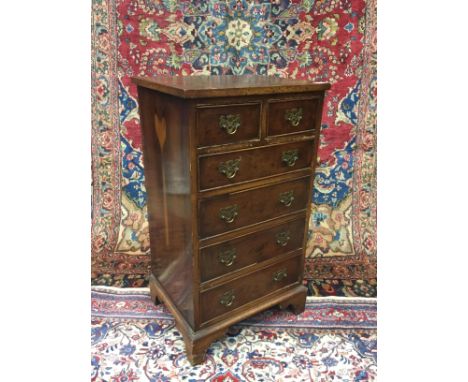 REPRODUCTION YEW-WOOD SLENDER CHEST, with two short and four long drawers, on bracket feet, 84cm high, 47cm wide