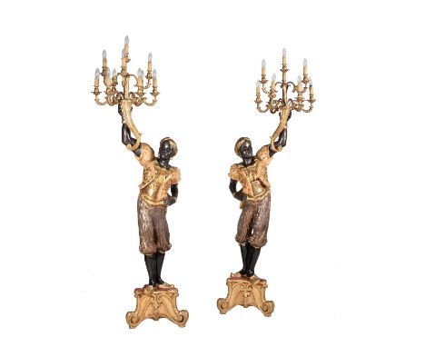 A pair of carved, painted, ebonised and parcel gilt wood blackamoor torcheres, 20th century, in the manner of 18th century Ve