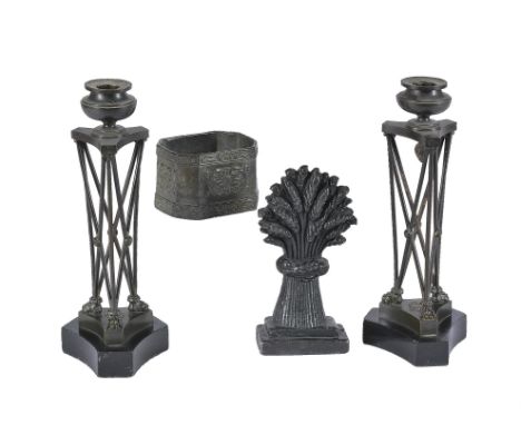 A pair of French patinated and lacquered metal candlesticks in Neoclassical style, mid-19th century, the squat engine turned 