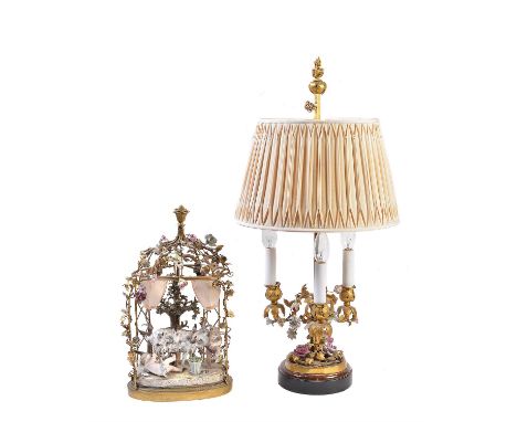 A German porcelain and gilt metal mounted twin light table lamp, late 19th/early 20th century, the central figural group with