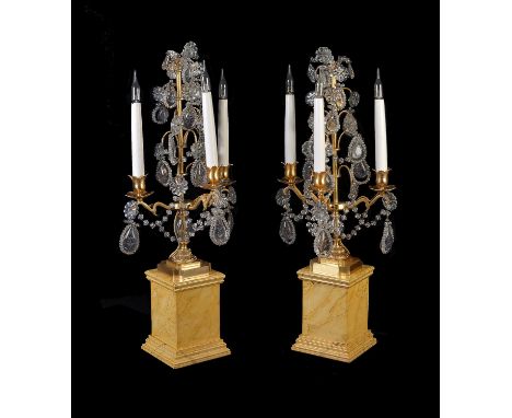 A pair of Continental gilt metal, moulded and engraved glass three light candelabra, in 18th century style, 20th century, the