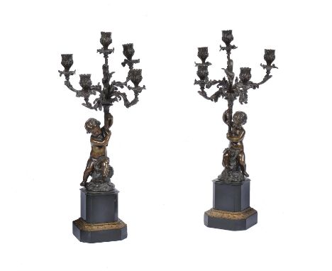 A pair of French patinated bronze, gilt metal and marmo nero Belgio five light candelabra, circa 1880, each with rocaille and