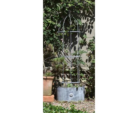 A metal planter, modern, of demilune section and with trellis frame to top