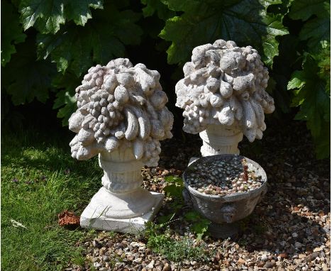 A pair of reconstituted stone finials modelled as fruit and flower vases, 20th century, approximately 55cm high; along with a