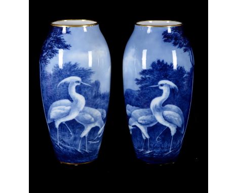 A pair of large Limoges porcelain (M. Frères) ovoid vases signed by N. Etienne, circa 1900, painted in blue with wading birds
