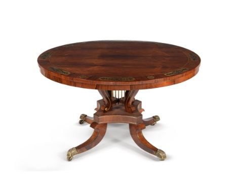 Y A Regency rosewood and brass inlaid circular centre table, circa 1820, on a lyre shaped supports above the quadripartite pl