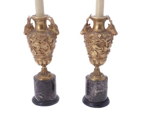 A pair of gilt metal and marble mounted urn table lamps, 20th century, the ovoid bodies with cast with flanking rams' masks a