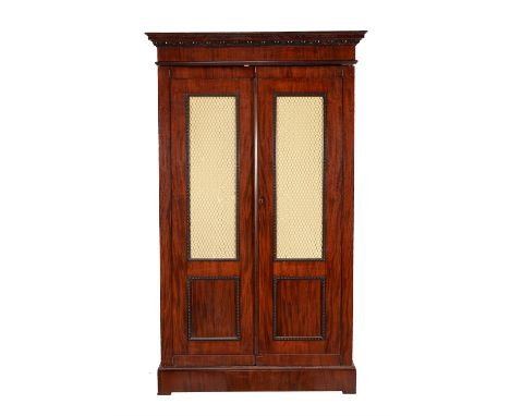 A French mahogany wardrobe, circa 1860 and later, the moulded cornice above a pair of panelled doors enclosing a hanging spac