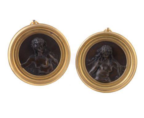 A pair of French patinated bronze relief roundels of nymphs, late 19th century, the maidens portrayed nude and with flowing h