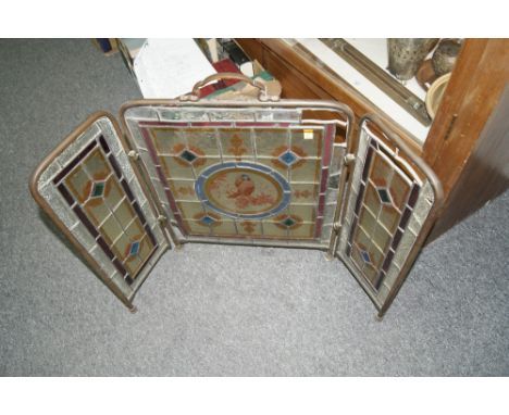 A VICTORIAN STAINED GLASS FOLDING BRASS FIRESCREEN, 42cm across