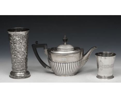 A SILVER OVAL HALF REEDED TEAPOT, a silver commemorative beaker, Elizabeth II 1952-1977, and a tall silver embossed beaker re