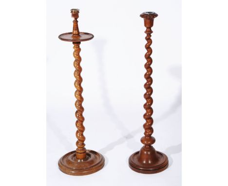 TWO SIMILAR 19TH CENTURY WALNUT CANDLESTICKS, one with top beaded shelf, both with barley twist column and rounded base, 93cm