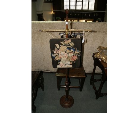 A VICTORIAN MAHOGANY POLE SCREEN with wool work panel on an adjustable column