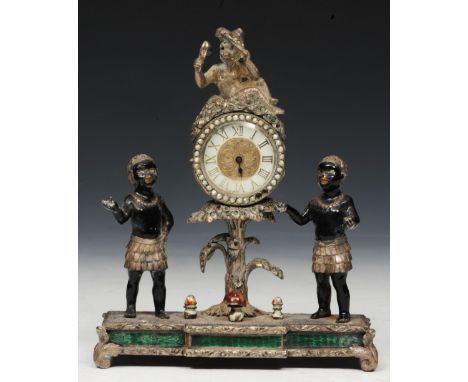 A SMALL SILVERED METAL AND ENAMEL MANTEL CLOCK in the form of a central dial flanked by two blackamoor and with monkey type f