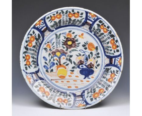 A DELFTWARE POLYCHROME  CHARGER with simple flower designs, 34cm